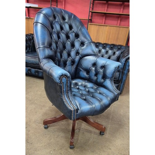 3 - A blue Chesterfield revolving desk chair