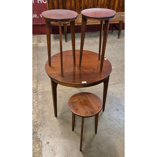 23 - A teak circular nest of tables