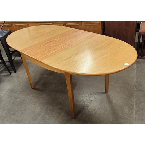 28 - A teak extending dining table