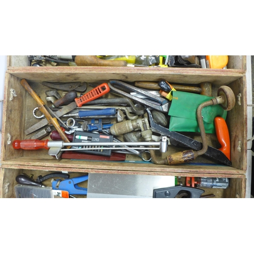 2028 - Four wooden trays containing a large quantity of assorted hand tools including saws, spanners, grips... 