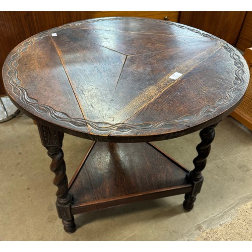 100 - A 17th Century style carved oak drop-leaf cricket table