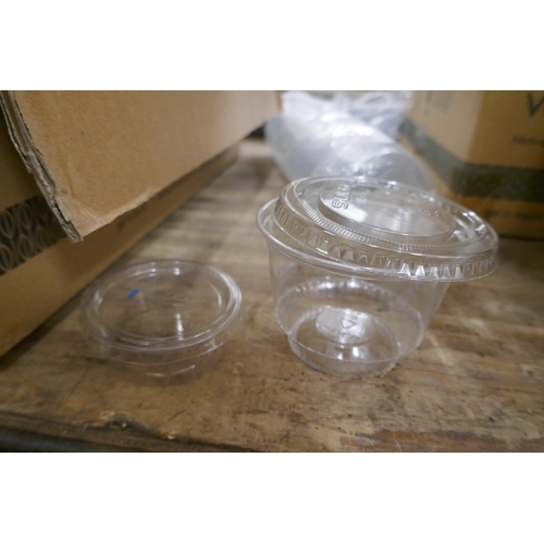 2309 - A large quantity of assorted clear plastic pots and lids