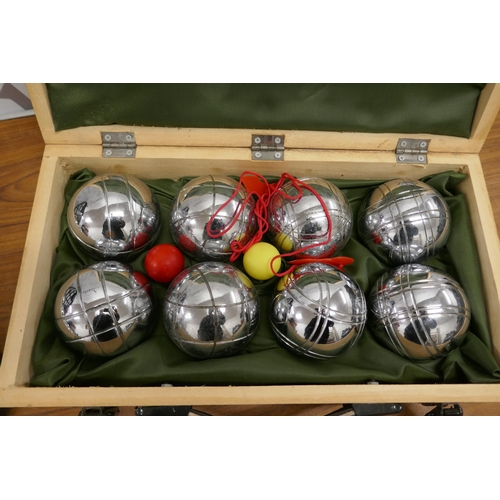 2314 - A set of Jonelle French boules in a wooden case and one other French boules garden game set