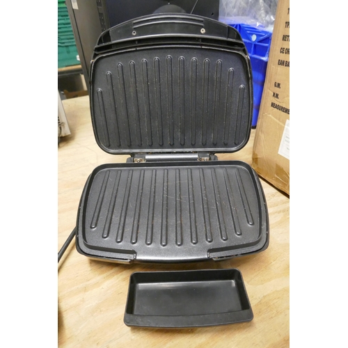 2323 - A George Foreman model 25820 grill and an Ambiano family grill