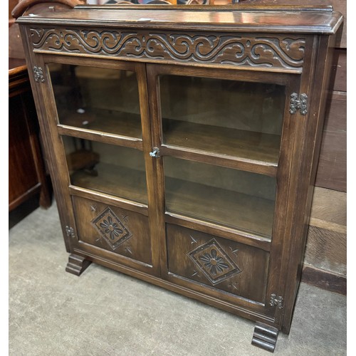 148 - A carved oak two door bookcase