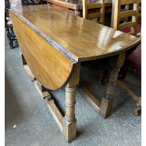 119 - A Nigel Griffiths carved oak drop-leaf dining table and six chairs