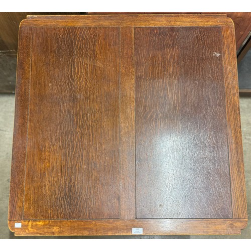 152 - An early 20th Century carved oak draw-leaf table