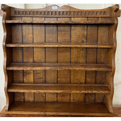 120 - A Nigel Griffiths carved oak wall hanging plate rack