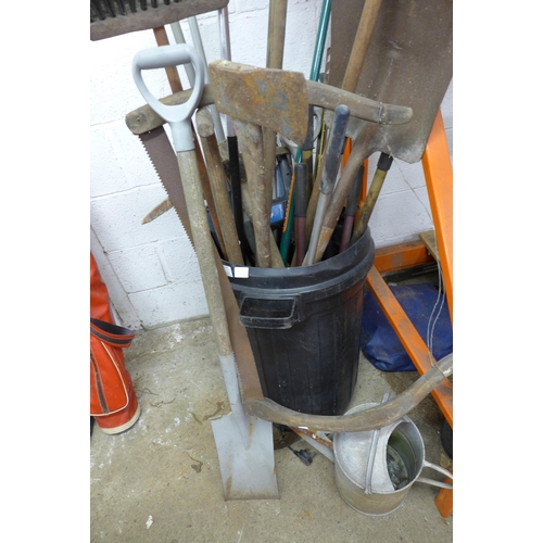 2196 - A large quantity of garden tools including a watering can, a rake, long reach clippers, a pickaxe, s... 