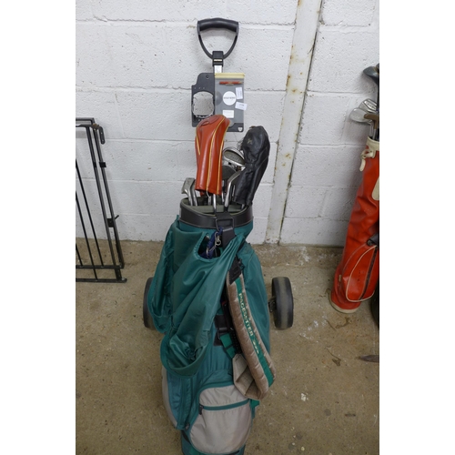 2198 - A Taylor Made Pace Setter golf bag with a set of Welby Deity golf clubs and a Golf King caddy trolle... 