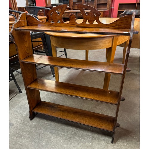 131 - An Arts and Crafts carved oak open bookcase