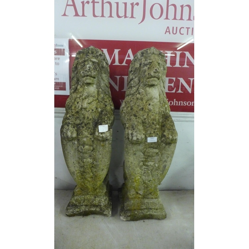 2097 - Two 3ft stone effect concrete lion figures with shields