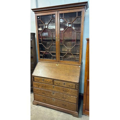 141 - A George III oak bureau bookcase
