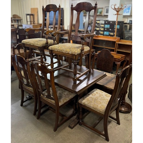 174 - An oak refectory table and eight chairs