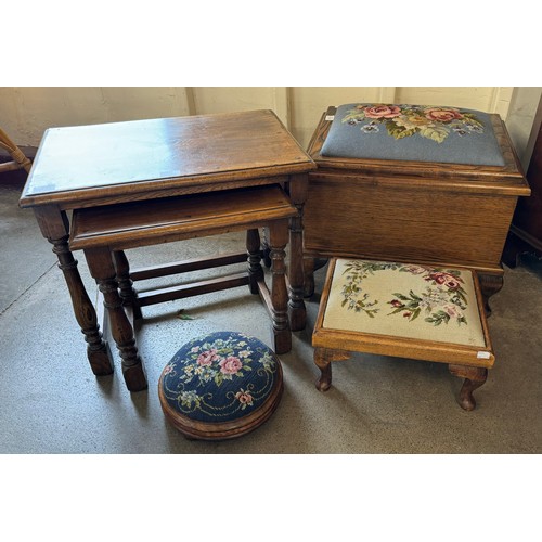 214 - An oak sewing box, two footstools and a nest of two tables