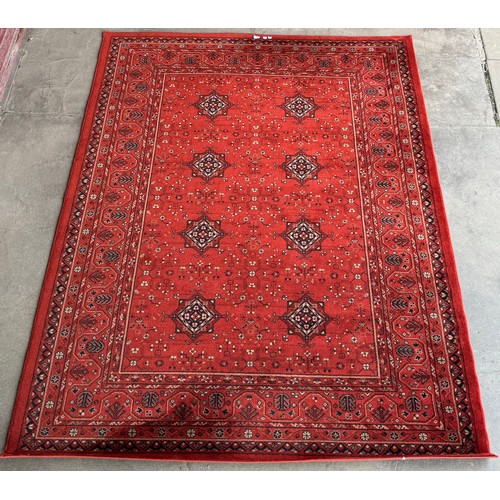 189 - A terracotta ground rug, 295cm x 200cm