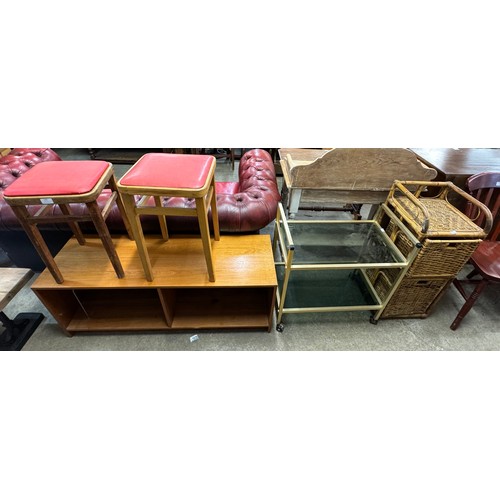 240 - A teak TV stand, a pair of stools, a bamboo storage stand and a metal trolley