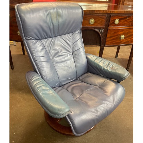 63 - A Norwegian Ekornes beech and blue leather revolving lounge chair