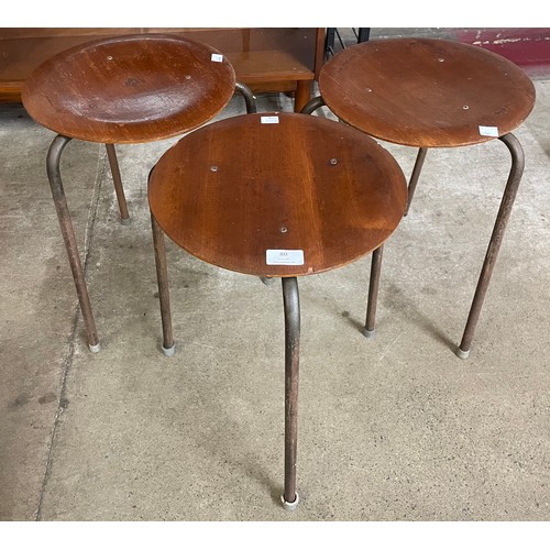 80 - A set of three Danish Fritz Hansen plywood and tubular metal three legged dot stools, designed by Ar... 