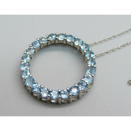 1007 - A 10kt white gold and blue stone pendant on a 10kt white gold chain, 2.9g