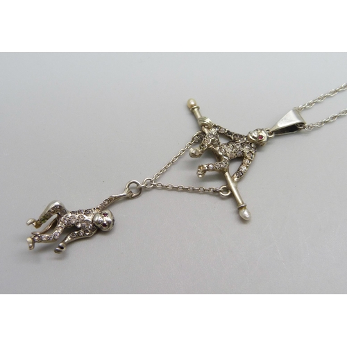 1014 - An Edwardian silver and paste monkey pendant