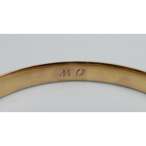 1024 - A 9ct gold faceted bangle, 11.8g, dented