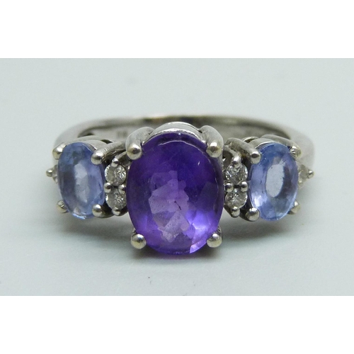 1030 - A 14ct white gold and three stone amethyst and six stone diamond ring, 4.8g, N