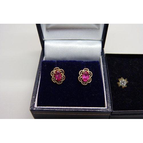 1034 - A pair of 9ct gold red stone earrings and a pair of yellow metal white stone earrings