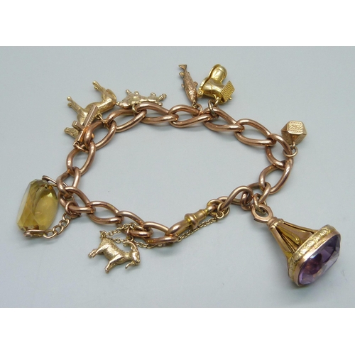 1051 - A 9ct gold charm bracelet, 63.3g, each link marked, fish charm not marked, all others hallmarked or ... 