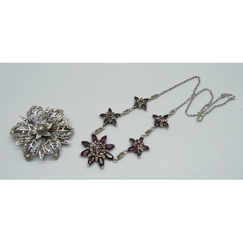 1059 - A silver, garnet and marcasite necklet and a silver and marcasite brooch