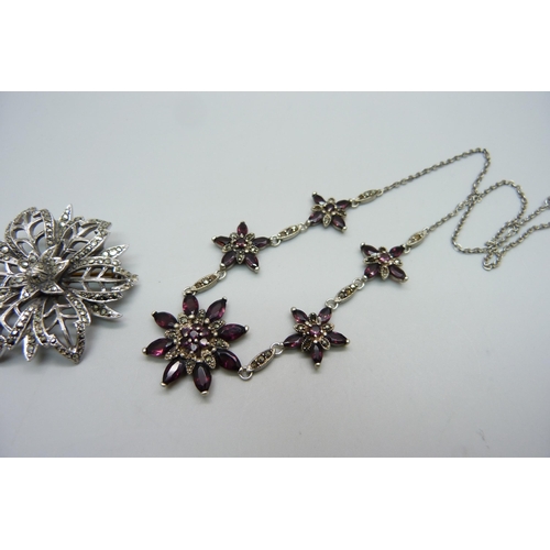 1059 - A silver, garnet and marcasite necklet and a silver and marcasite brooch