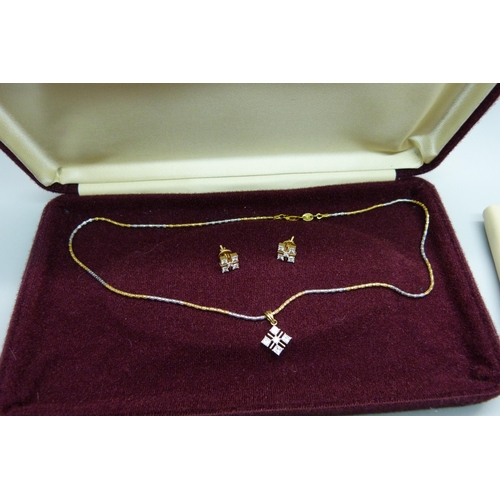 1063 - An 18ct gold and diamond pendant on a chain and a pair of similar earrings, with certificates, 1.27 ... 