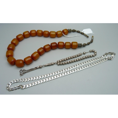 1096 - An amber coloured bead necklace, a silver curb link necklace, 28g, and a silver bead necklace