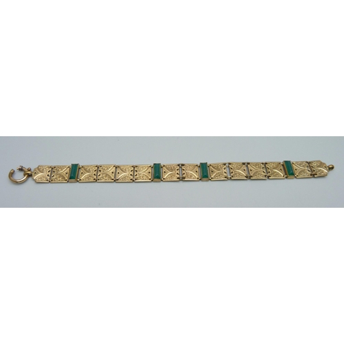 1116 - A rolled gold bracelet with green stones