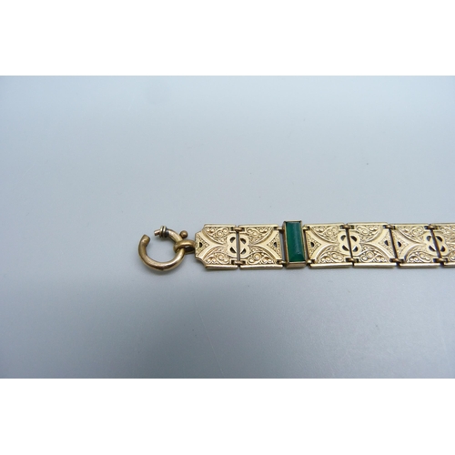 1116 - A rolled gold bracelet with green stones