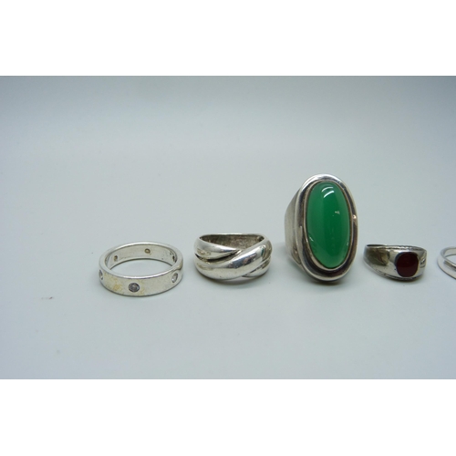 1123 - A silver and green stone ring and five other silver rings