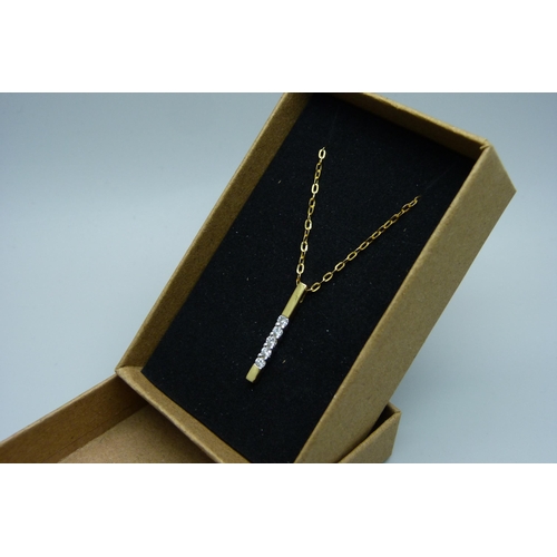 1127 - An 18ct gold five stone diamond pendant on an 18ct gold chain, 1.8g