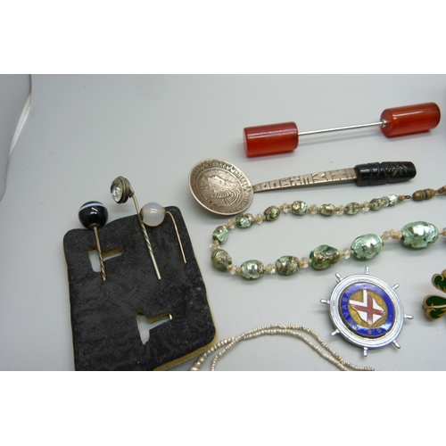 1146 - Assorted items including a foil necklace, travel clock, vesta, etc.