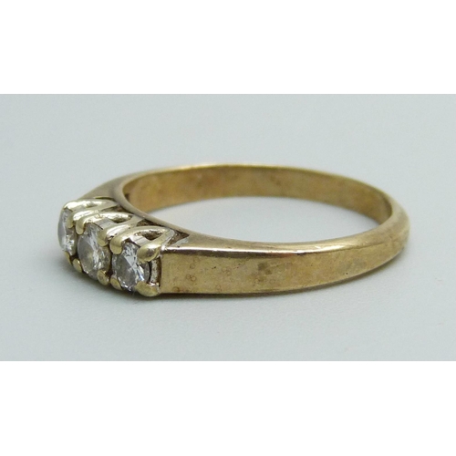 1168 - A 9ct gold ring set with three diamonds, 2.2g, M