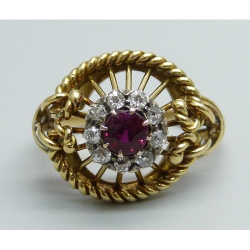 1170 - A yellow metal ring of openwork design, set with a ruby and diamond cluster, tests as 15ct gold, 6g,... 