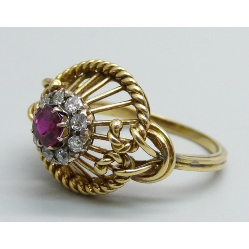 1170 - A yellow metal ring of openwork design, set with a ruby and diamond cluster, tests as 15ct gold, 6g,... 