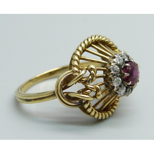 1170 - A yellow metal ring of openwork design, set with a ruby and diamond cluster, tests as 15ct gold, 6g,... 