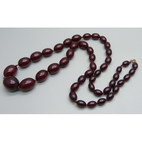 1171 - A string of sherry amber beads, 50.3g