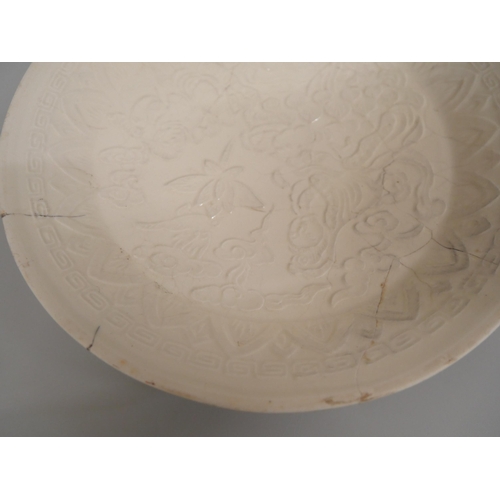 607 - A small Chinese porcelain relief moulded charger, 20.5cm, a/f