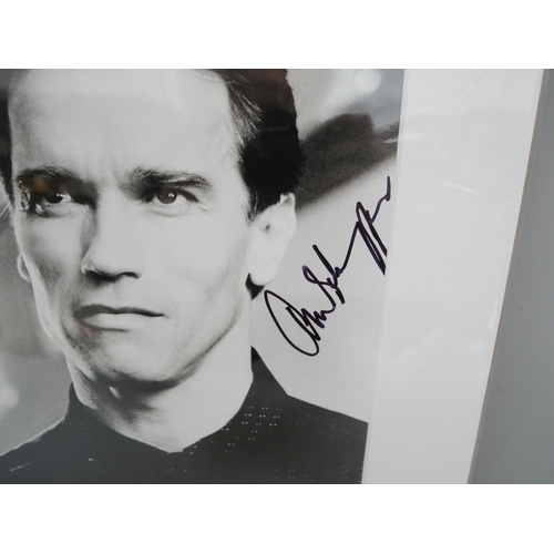608 - An Arnold Schwarzenegger signed photograph, mounted