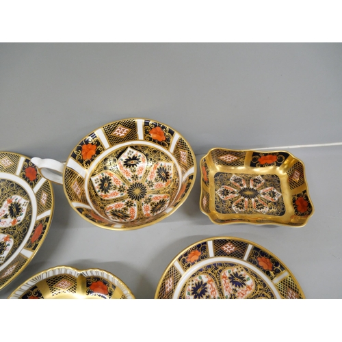 637 - A Royal Crown Derby 1128 Imari cup and saucer and three pin trays