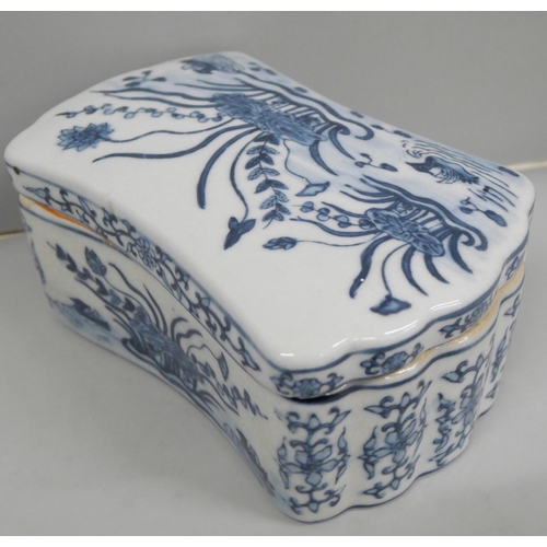 638 - An oriental blue and white lidded box, 15cm wide
