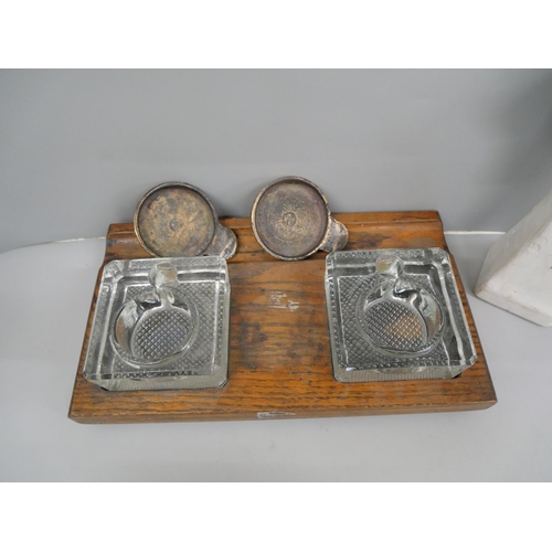 643 - A Victorian desk top set with two glass and brass ink bottles on an oak stand, and a plaster figure ... 