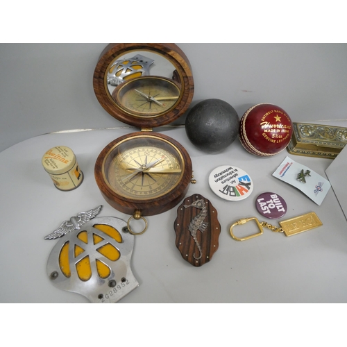 685 - A cannonball, a Hurricane Indian cricket ball, badges, compass, etc.
