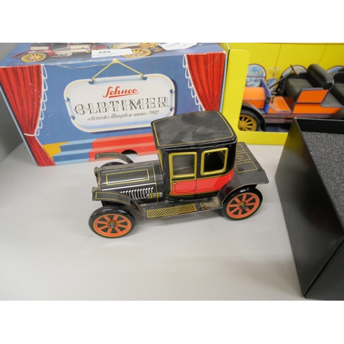 688 - A Schuco Old Timer tinplate car, a Chinese vintage Shanghai tram, Bugatti racer, all boxed and one o... 
